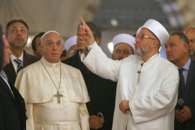 Pope Francis listens to Rahmi Yaran Mufti of Istanbul during visit to Hagia Sophia in Istanbul