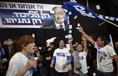 Likud party supporters react after hearing exit poll results in Tel Aviv