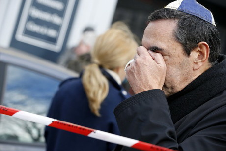 A man  wearing kippa cries near a kosher grocery store in Porte de Vincennes, eastern Paris, on January 10, 2015 a day after four people were killed at the Jewish supermarket by jihadist gunman Amedy Coulibaly during a hostage-taking. French forces were on January 10 frantically hunting for the Coulibaly's 26-year-old girlfriend, Hayat Boumeddiene, as the country mourned 17 dead in three blood-soaked days, hours after a dramatic end to twin sieges that also resulted in the death of two brothers who had killed 12 at the offices of the Charlie Hebdo magazine on January 7. AFP PHOTO / KENZO TRIBOUILLARD        (Photo credit should read KENZO TRIBOUILLARD/AFP/Getty Images)