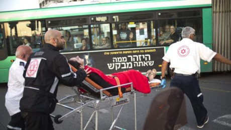 Israeli rescue personal evacuate a woman from a stabbing attack site in Rishon Lezion, Israel, Monday, Nov. 2, 2015. Israels emergency rescue service said two people were seriously injured and one lightly in the attack in Rishon Lezion near Tel Aviv. (AP Photo/Ariel Schalit)