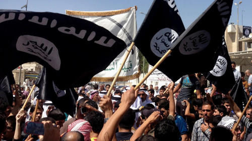 Demonstrators chant in support of the group known as the Islamic State of Iraq and Syria as they wave the group's flag in front of the provincial government headquarters in Mosul, Iraq, on Monday, after the Sunni militants captured Tal Afar, another northern Iraqi town.