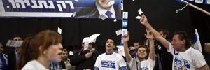 Likud party supporters react after hearing exit poll results in Tel Aviv